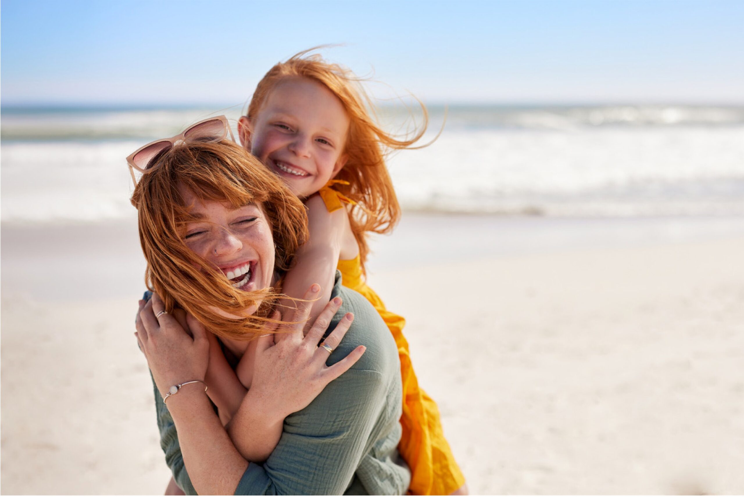 mother and child smiling on the beach